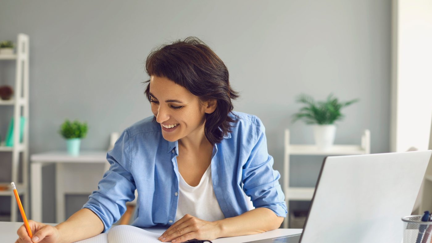 A professional working thoughtfully at a laptop